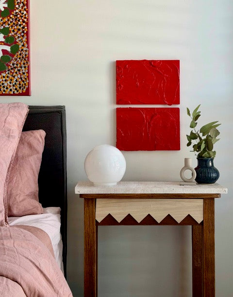 Red Impasto paintings by Tory Burke hung as a pair in a styled interior