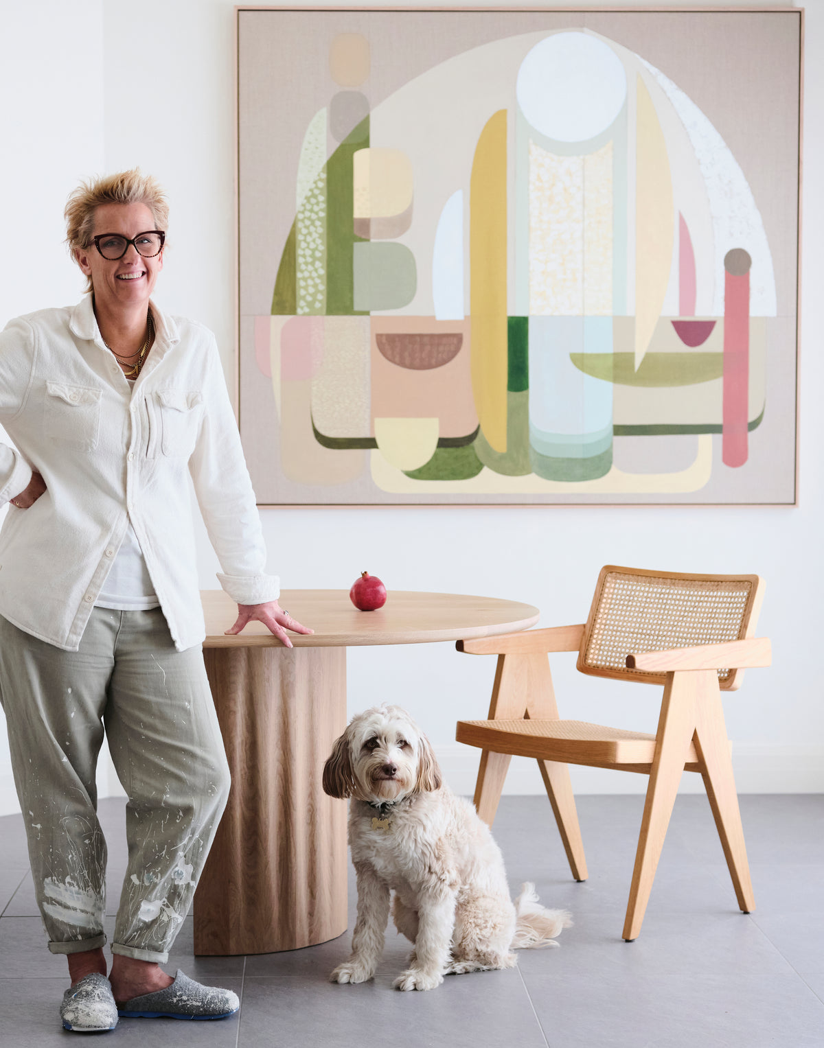 Adonis abstract wall art print XL, artist standing beside large-scale geometric giclée in sage, blush and warm neutrals