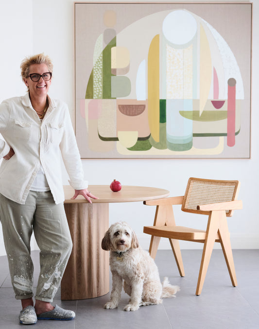 Adonis abstract wall art print XL, artist standing beside large-scale geometric giclée in sage, blush and warm neutrals