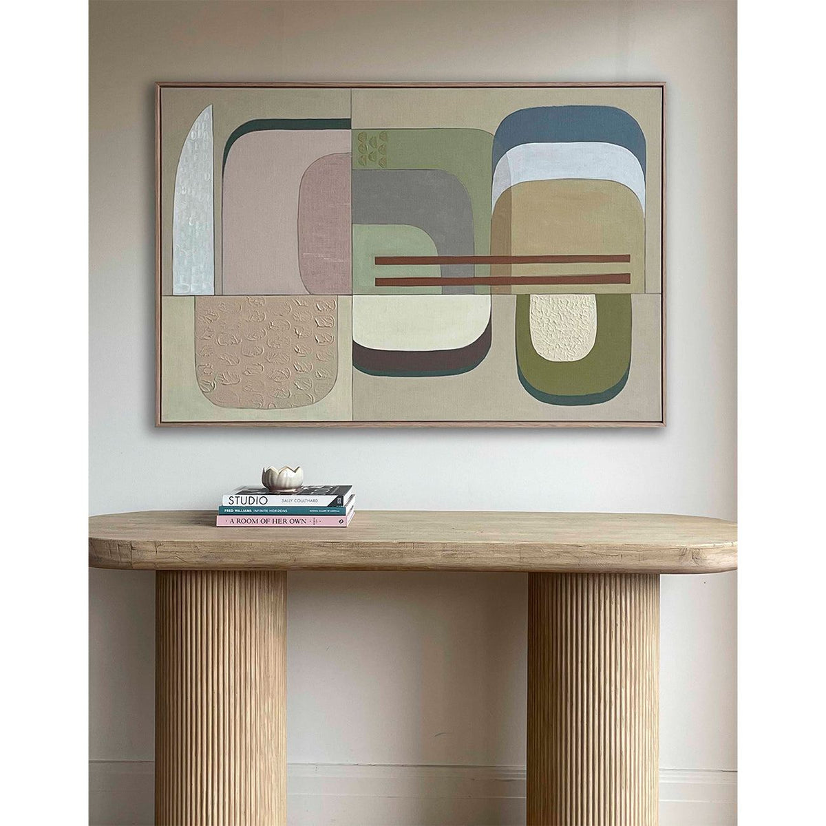 Large abstract wall art above sofa in modern living room with neutral styling