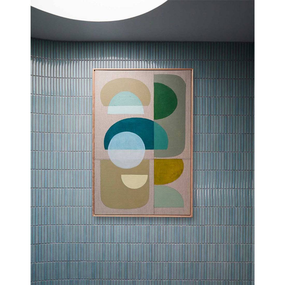 Framed Giclee wall art print featuring overlapping geometric shapes in green and blue on a neutral background, displayed on an arched wall.