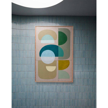 Framed Giclee wall art print featuring overlapping geometric shapes in green and blue on a neutral background, displayed on an arched wall.