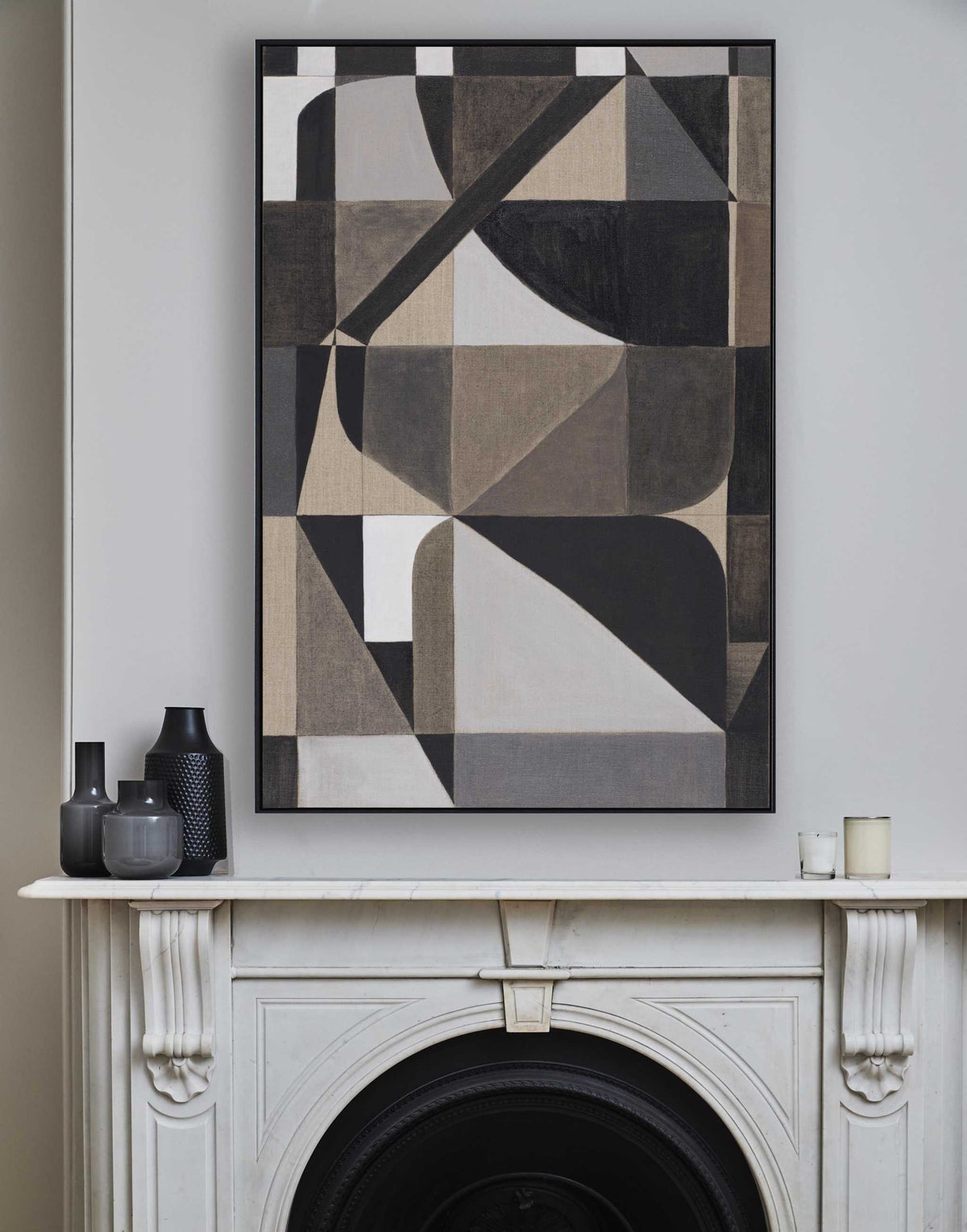 Framed Giclee print featuring geometric abstract shapes in black, white, and gray, displayed above a fireplace.