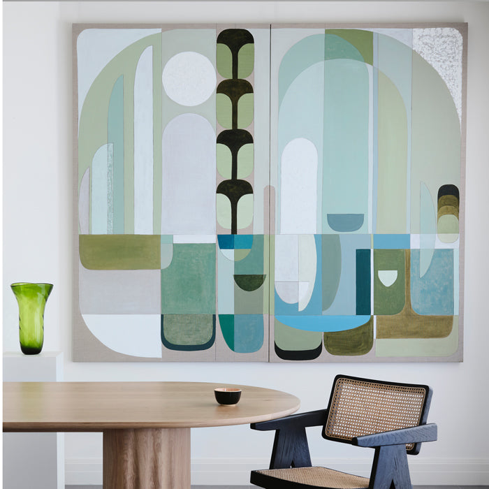 Abstract wall art on a wall above a table and chair