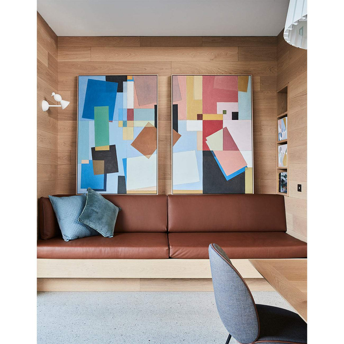 Framed Giclee print featuring geometric design with dominant blue color, displayed on a wall above a contemporary living room sofa.