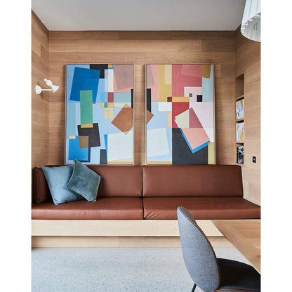 Framed Giclee print featuring geometric design with dominant blue color, displayed on a wall above a contemporary living room sofa.