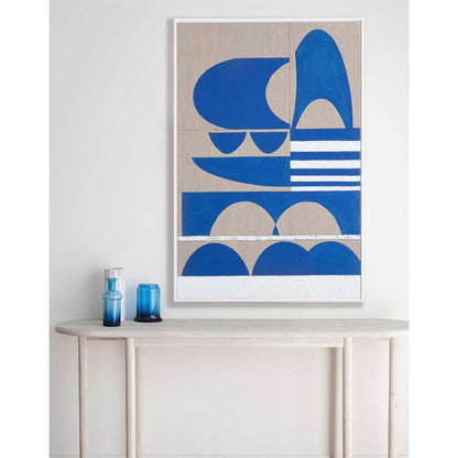 Framed Giclee print featuring geometric patterns with blue and beige tones, displayed on a wall above a white console table with a blue vase containing flowers.