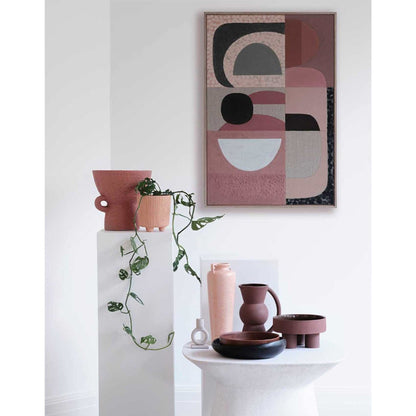 Pink Stucco - Giclee print artwork framed in raw oak on a white wall with vase and climber