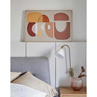 An abstract modern artwork titled 'Terracotta Arch', featuring geometric shapes in warm terracotta hues, displayed above a bed in a room setting.